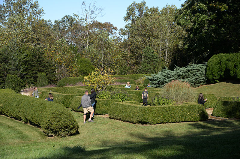 People walking through a formal garden